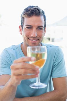 Smiling young man holding wine glass