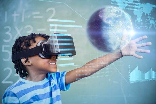 Earth globe against school boy in virtual reality glasses in classroom