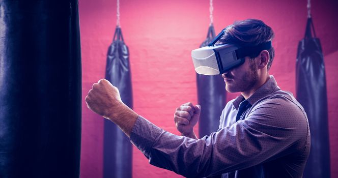 Composite image of man using an oculus and fighting