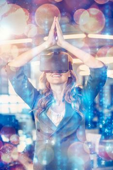 Businesswoman with hands joined using virtual reality simulator 