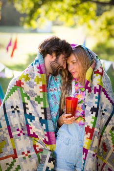Couple wrap themselves in blanket