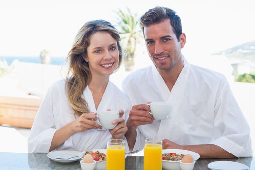 Smiling young couple having breakfast