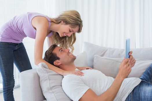 Woman with man using digital tablet