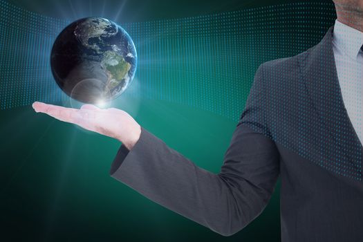 Businessman holding an earth hologram