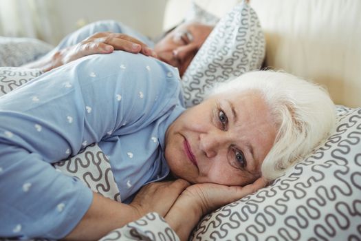 Senior woman awake on bed