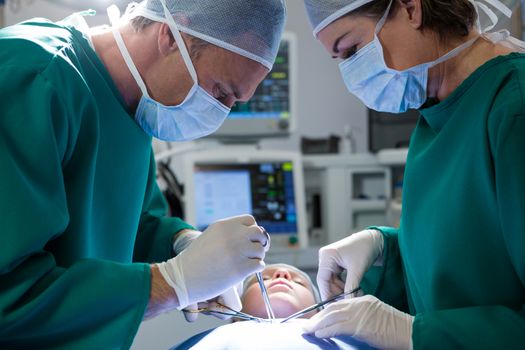 Surgeons operating patient