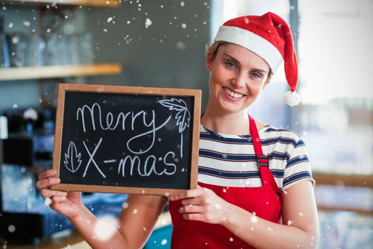 Composite image of portrait of waitress showing slate with merry x-mas sign