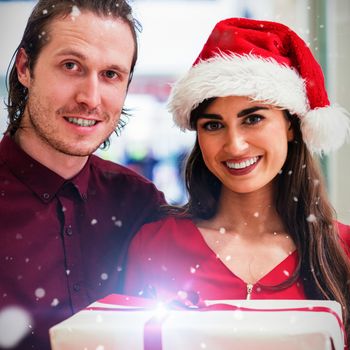 Composite image of portrait of couple in christmas attire standing