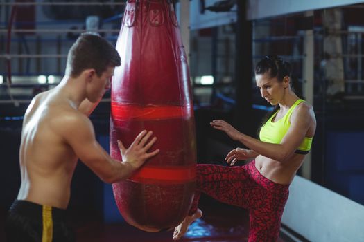 Female boxer practicing a kick boxing