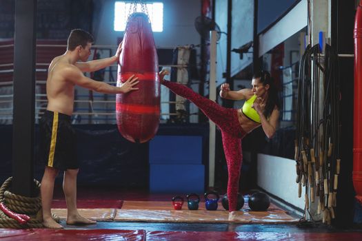 Female boxer practicing a kick boxing