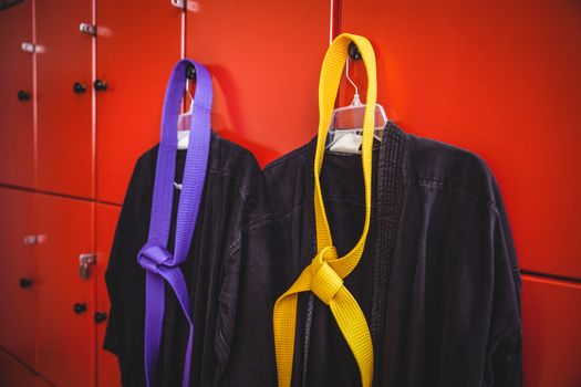 Two karate uniforms hanging on locker