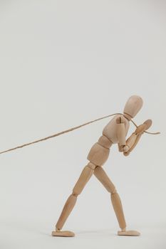 Wooden figurine pulling a rope