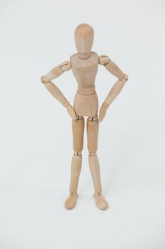 Wooden figurine standing with hands on hips