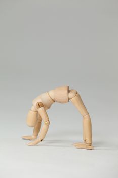 Wooden figurine exercising on floor