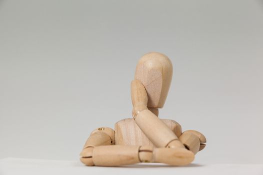 Wooden figurine leaning on table