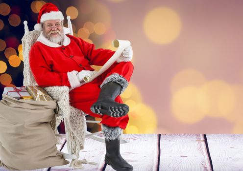 Santa claus holding wish list with sack of gifts