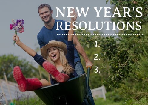 New year resolutions against couple enjoying with wheel barrow