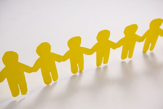 Row of yellow paper cut-out figures