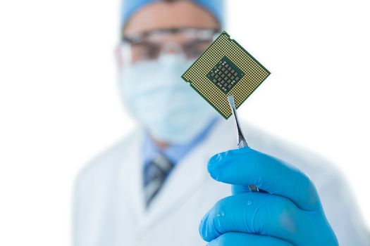 Doctor holding electronic chip with forceps