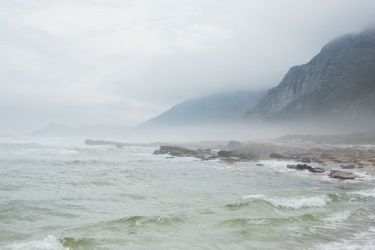 Ocean against the misty mountains