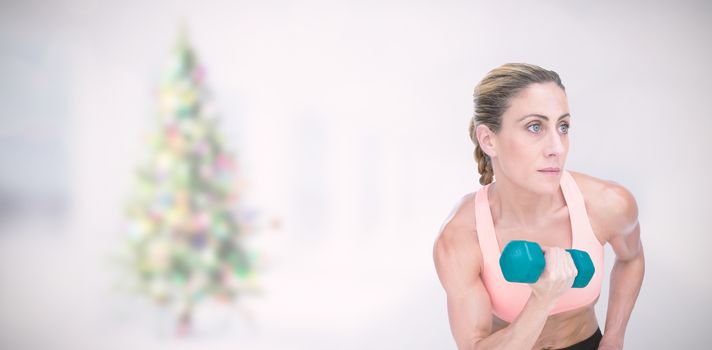 Composite image of strong woman doing bicep curl with blue dumbbell