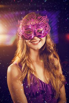 Composite image of woman wearing masquerade in bar