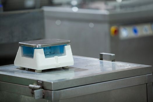 Weighing scale on worktop at meat factory