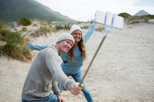 Happy couple taking a selfie from selfie stick