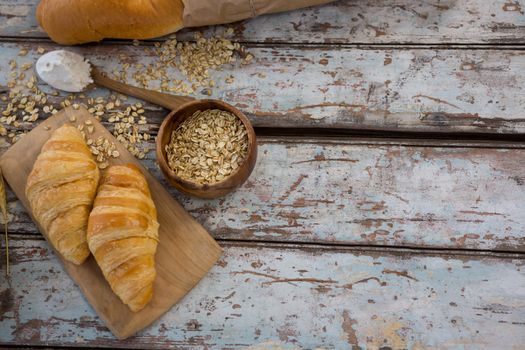 Croissants, oats and spoon with flour