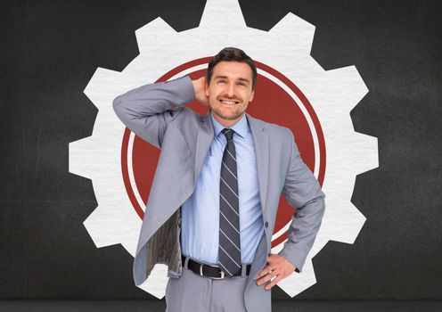 Smiling businessman standing with hand on hip