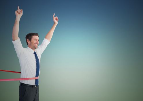 Businessman crossing finish line with arms up