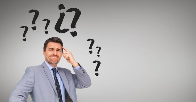 Businessman with question mark surrounding his head
