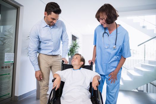 Man and doctor interacting with disable boy