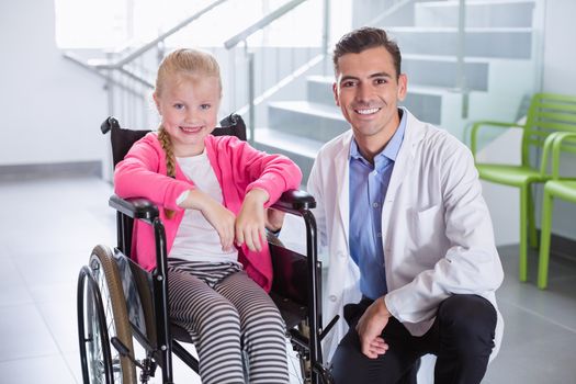 Portrait of smiling doctor and disable girl