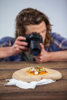 Male photographer photographing food