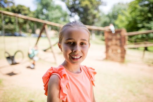 Portrait of innocent girl smiling in park