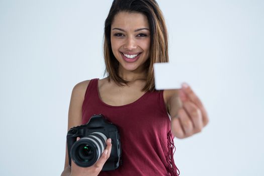 Female photographer showing visiting card in studio