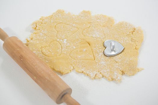 Rolling pin and cookie cutter on dough