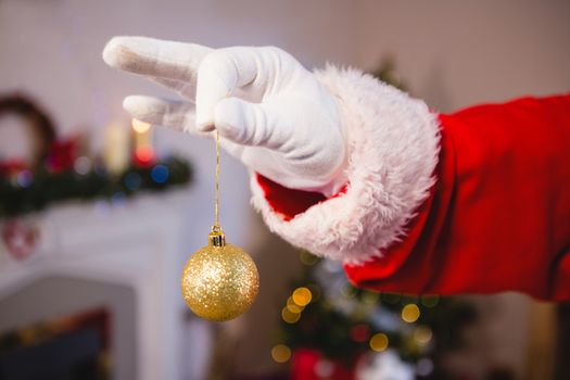 Santa claus holding a bauble