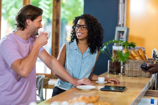Couple interacting with each other at counter