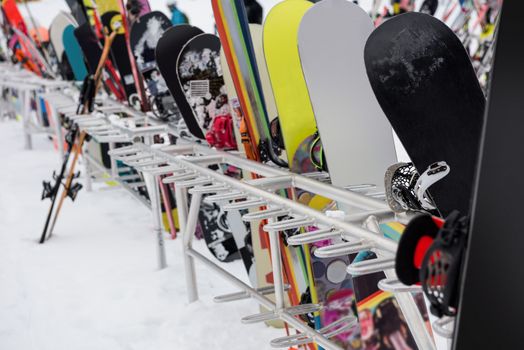 Snowboards and skis kept together at ski resort
