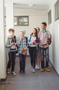 Group of classmate walking in corridor 