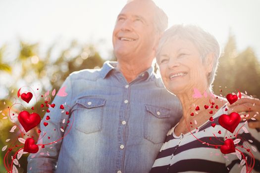 Composite image of senior couple and valentines hearts 3d