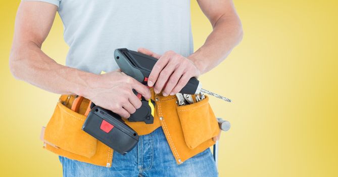 Mid-section of handy man with tool belt and drill