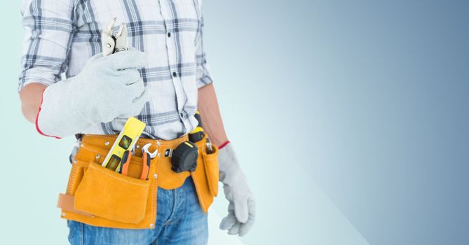 Mid section of handyman with tool belt and wrench