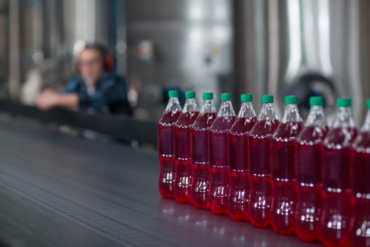 Bottles of juice on conveyer belt