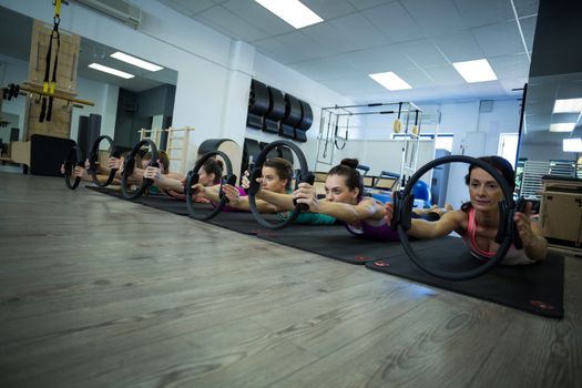 Group of women exercising with pilates ring