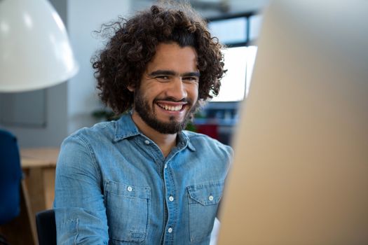 Smiling graphic designer working on computer