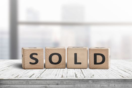 Sold sign on a wooden table