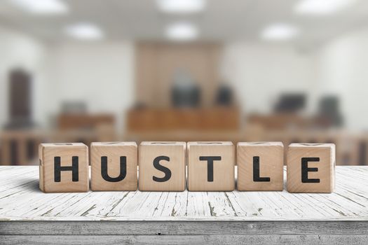 Hustle sign with text on a worn desk